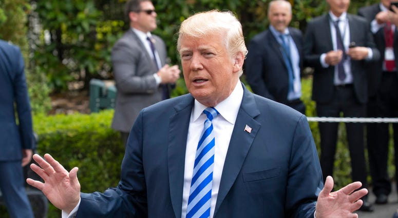 President Donald Trump talks to the media as he leaves for Dallas to address the National Rifle Association, President Trump
