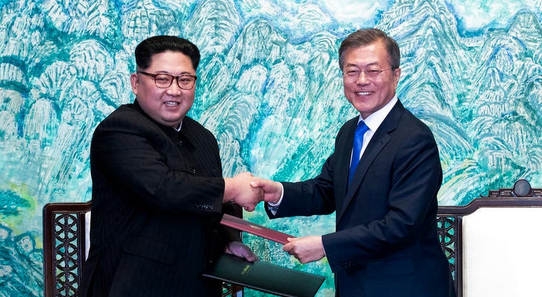 North Korean leader Kim Jong Un, left, and South Korean President Moon Jae-in shake hands after signing on a joint statement at the border village of Panmunjom in the Demilitarized Zone DO NOT USE