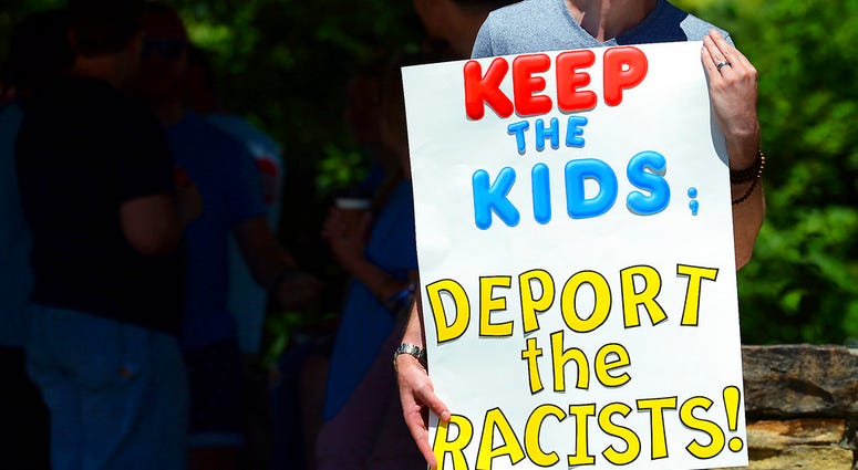 Chris Olson, of Lake Wallenpaupack, Pa., holds a sign outside Lackawanna College where U.S. Attorney Jeff Sessions spoke on immigration policy and law enforcement actions, DO NOT USE