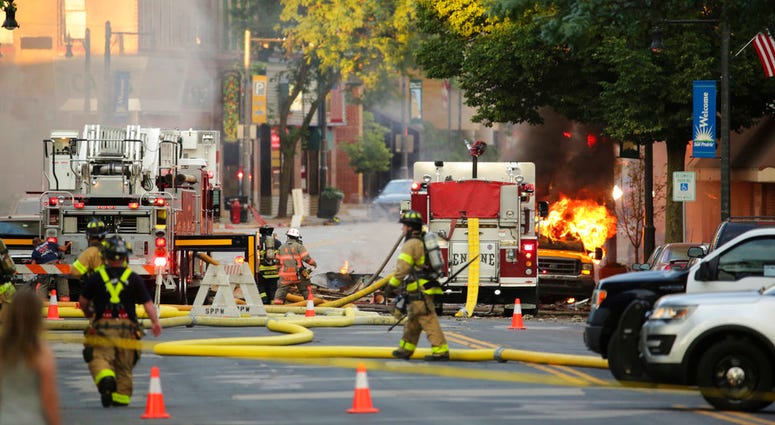 Firefighters work the scene of an explosion in downtown Sun Prairie, Wis., Tuesday, July 10, 2018. DO NOT USE