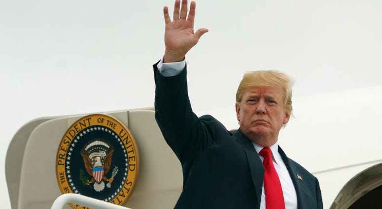 President Donald Trump waves as he boards Air Force One at Morristown Municipal Airport, in Morristown, N.J., Sunday, July 22, 2018, en route to Washington after staying at Trump National Golf Club in Bedminster, N.J. DO NOT USE