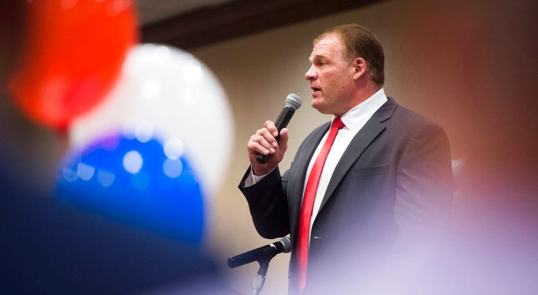 Republican Glenn Jacobs speaks to a crowd after early results showed him winning the mayoral race, Thursday, Aug. 2, 2018, in Knoxville, Tenn. Jacobs, who is also the WWE wrestler known as Kane, defeated Democrat Linda Haney. DO NOT USE