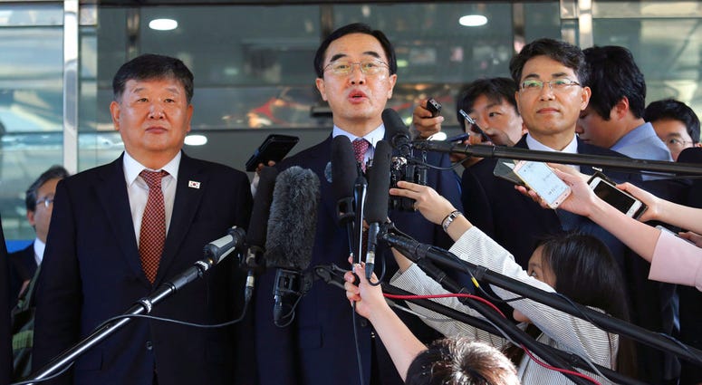 In this June 1, 2018, file photo, South Korean Unification Minister Cho Myoung-gyon, center, speaks to the media before leaving for the border village of Panmunjom to attend South and North Korean meeting. DO NOT USE