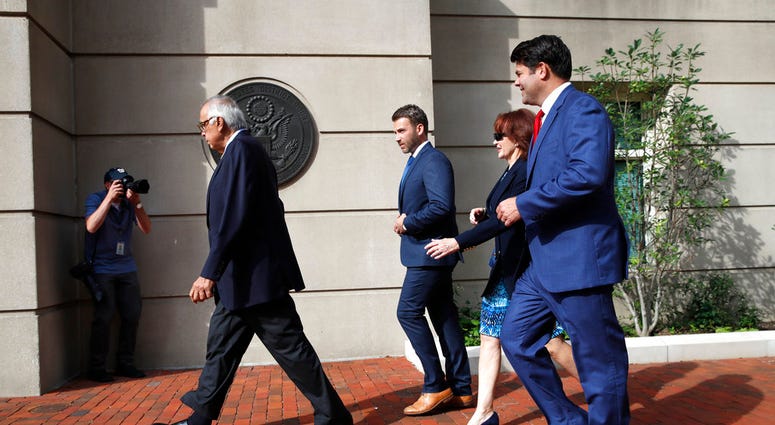 Paul Manafort's wife Kathleen Manafort, second from right, walks next to Manafort spokesman Jason Maloni, right, as they arrive at federal court for the second day of jury deliberations in the trial of the former Trump campaign chairman DO NOT USE