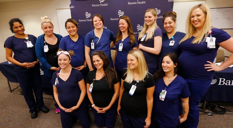 Most of the sixteen pregnant nurses who work together in the intensive care unit at Banner Desert Medical Center pose for a group photograph after attending a news conference where they all talked about being pregnant at the same time DO NOT USE