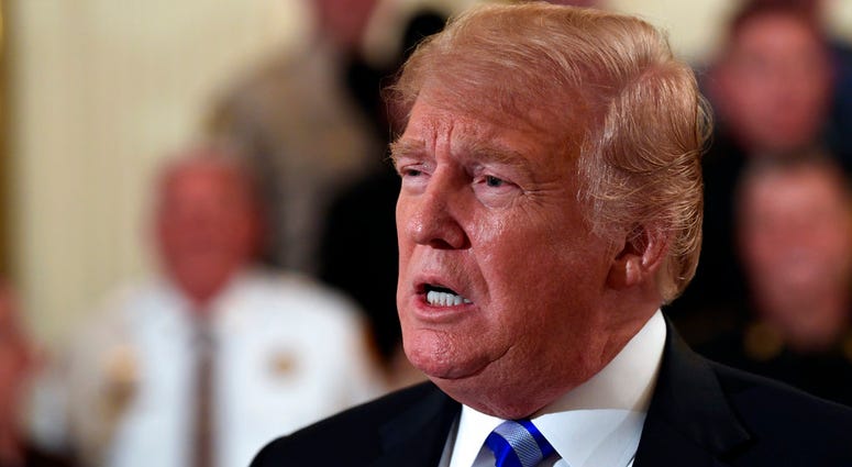 President Donald Trump responds to a reporters question during an event with sheriffs in the East Room of the White House in Washington, Wednesday, Sept. 5, 2018. DO NOT USE