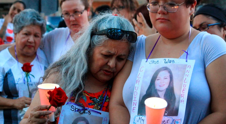 Dozens of family members and friends of four women who authorities say were killed by a U.S. Border Patrol agent gather for a candlelight vigil at a park in downtown Laredo, Texas, on Tuesday, Sept. 18, 2018. DO NOT USE