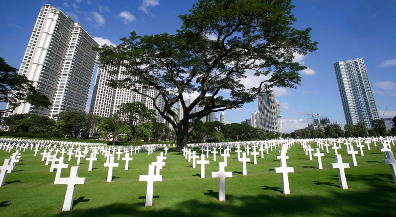 In this Nov. 11, 2012, file photo, rows of crosses totaling 16,933 Latin crosses, 164 Stars of David and 3,740 unknowns, dot the 152-acre American Cemetery on U.S. Veterans Day at the American Cemetery at suburban Taguig city, east of Manila, Philippines DO NOT USE