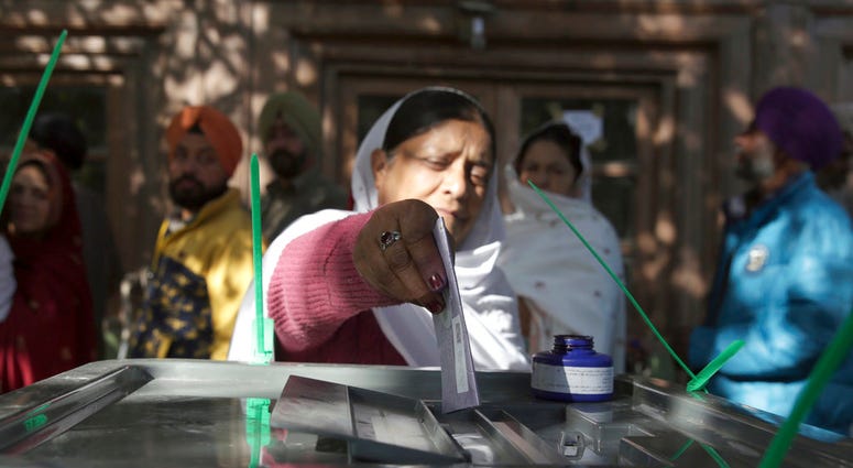 A woman from the minority Sikh casts her vote in Parliamentary elections in old city of Kabul, Afghanistan, A woman from the minority Sikh casts her vote in Parliamentary elections in old city of Kabul, Afghanistan,