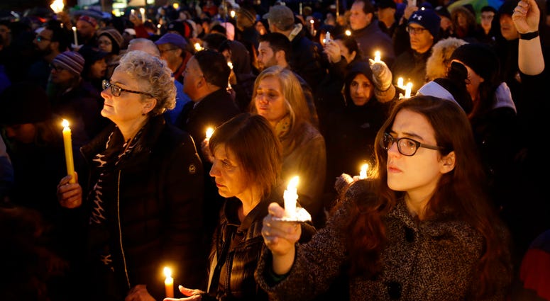 People hold candles as they gather for a vigil in the aftermath of a deadly shooting at the Tree of Life Congregation, in the Squirrel Hill People hold candles as they gather for a vigil in the aftermath of a deadly shooting at the Tree of Life Congregation, in the Squirrel Hill