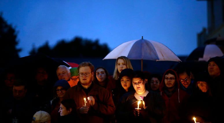 People hold candles as they gather for a vigil in the aftermath of a deadly shooting at the Tree of Life Congregation, in the Squirrel Hill People hold candles as they gather for a vigil in the aftermath of a deadly shooting at the Tree of Life Congregation, in the Squirrel Hill