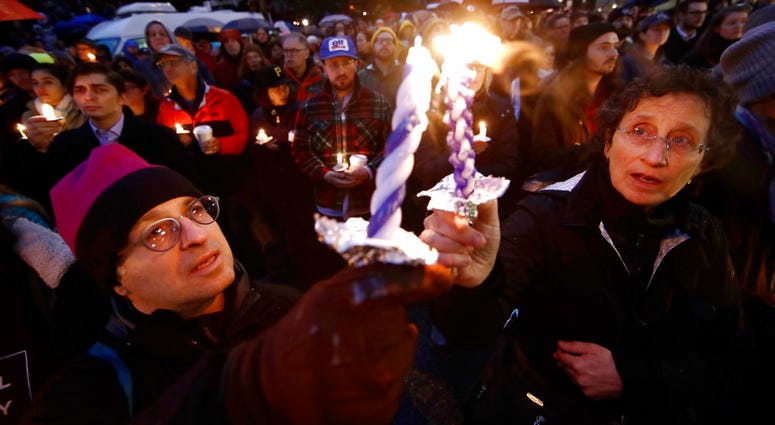 People hold candles as they gather for a vigil in the aftermath of a deadly shooting at the Tree of Life Congregation, in the Squirrel Hill People hold candles as they gather for a vigil in the aftermath of a deadly shooting at the Tree of Life Congregation, in the Squirrel Hill