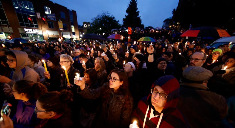 People hold candles as they gather for a vigil in the aftermath of a deadly shooting at the Tree of Life Congregation, in the Squirrel Hill People hold candles as they gather for a vigil in the aftermath of a deadly shooting at the Tree of Life Congregation, in the Squirrel Hill