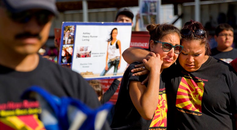 Jenna Loring, left, the aunt of Ashley HeavyRunner Loring, cries with her cousin, Lissa Loring, during a traditional blanket dance before the crowd at the North American Indian Days celebration on the Blackfeet Indian Reservation in Browning, Mont. Jenna Loring, left, the aunt of Ashley HeavyRunner Loring, cries with her cousin, Lissa Loring, during a traditional blanket dance before the crowd at the North American Indian Days celebration on the Blackfeet Indian Reservation in Browning, Mont.