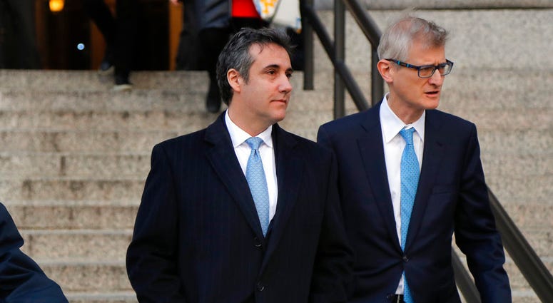 Michael Cohen, left, walks out of federal court with his attorney Guy Petrillo, Thursday, Nov. 29, 2018, in New York, after pleading guilty to lying to Congress about work he did on an aborted project to build a Trump Tower in Russia. DO NOT USE