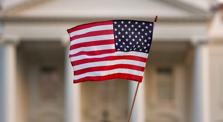 In this Sept. 2017 file photo, a flag is waved during an immigration rally outside the White House, in Washington. DO NOT USE