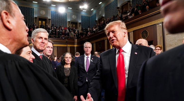 President Donald Trump talks to Supreme Court Chief Justice John Roberts AP DO NOT USE