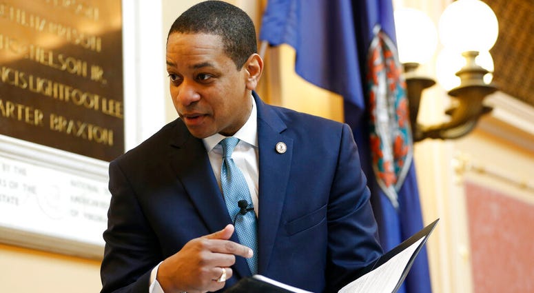 Virginia Lt. Gov Justin Fairfax looks over a briefing book prior to the start of the senate session at the Capitol in Richmond, Va., Thursday, Feb. 7, 2019. DO NOT USE