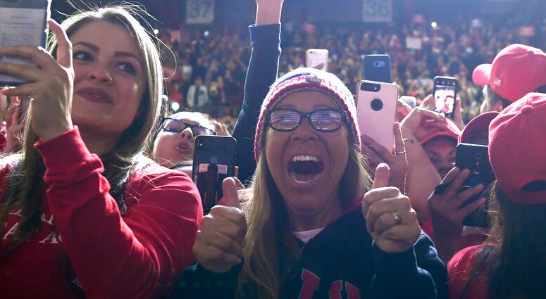 People respond as President Donald Trump speaks during a rally in El Paso, Texas, Monday, Feb. 11, 2019. DO NOT USE