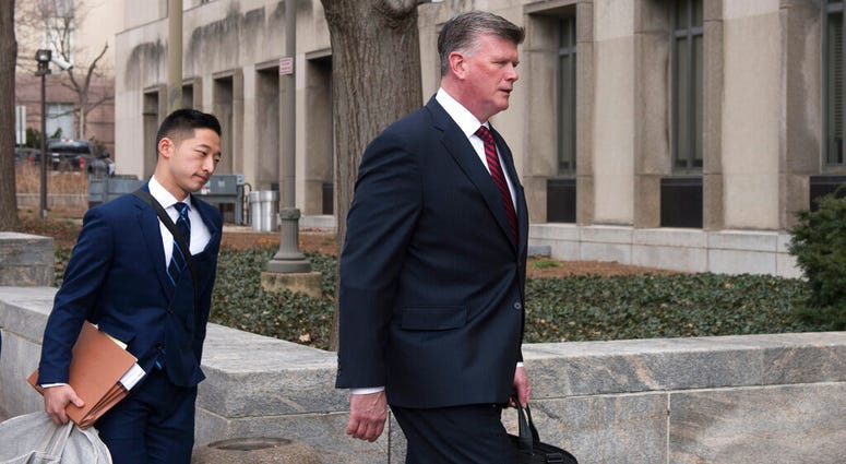 Kevin Downing, Paul Manafort's defense attorney, right, walks to the entrance of federal court on Wednesday, Feb. 13, 2019 in Washington. DO NOT USE