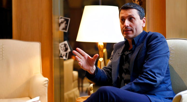 French writer Frederic Martel gestures during an interview with Associated Press, in Paris, Friday, Feb. 15, 2019. AP DO NOT USE