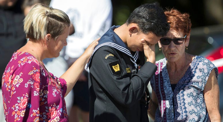 Abdul Iskandar, a sailor of Malaysian Royal Navy, cries after offering flowers outside the Al Noor mosque in Christchurch, New Zealand, Tuesday, March 19, 2019. DO NOT USE