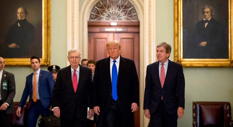 President Donald Trump accompanied by Senate Majority Leader Mitch McConnell of Ky., left, and Sen. Roy Blunt, R-Mo., right, arrives for a Senate Republican policy lunch on Capitol Hill in Washington AP DO NOT USE