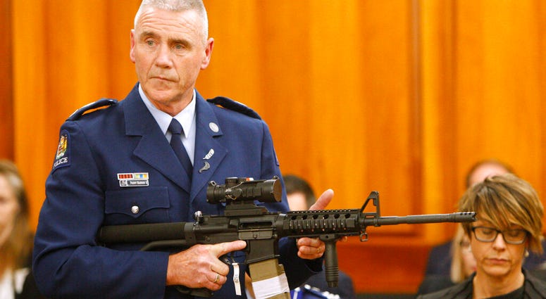 Police Sr. Sgt. Paddy Hannan shows New Zealand lawmakers in Wellington Tuesday, April 2, 2019, an AR-15 style rifle similar to one of the weapons a gunman used to slaughter 50 people at two mosques AP DO NOT USE