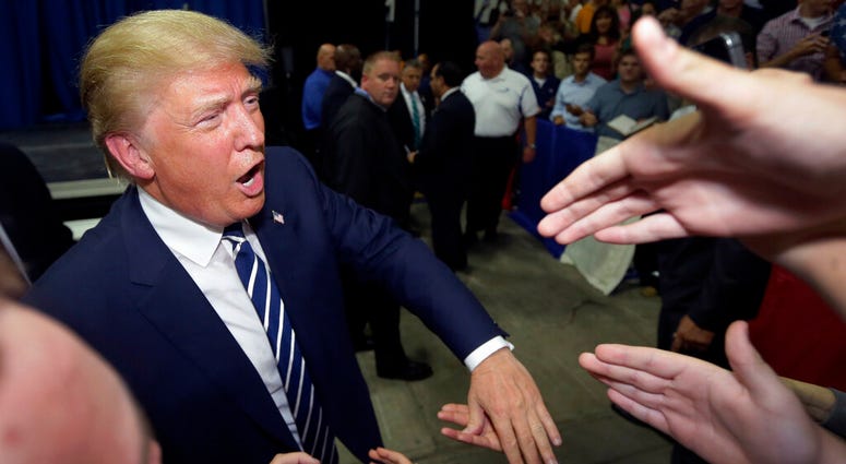 In this Aug. 11, 2015, file photo, Republican presidential candidate Donald Trump meets supporters after addressing a GOP fundraising event in Birch Run, Mich. AP DO NOT USE