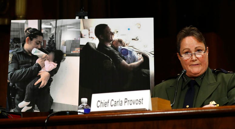 U.S. Border Patrol Chief Carla Provost testifies by a photo of agents with children during a Senate Judiciary Border Security and Immigration Subcommittee hearing about the border, Wednesday May 8, 2019, on Capitol Hill in Washington. U.S. Border Patrol Chief Carla Provost testifies by a photo of agents with children during a Senate Judiciary Border Security and Immigration Subcommittee hearing about the border, Wednesday May 8, 2019, on Capitol Hill in Washington.