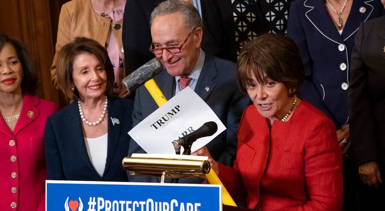 Rep. Anna Eshoo, D-Calif., right, chair of the House Health Subcommittee, says President Donald Trump and Attorney General William Barr want to take a sledgehammer to health care, as she joins, from left, Rep. Lisa Blunt Rochester, D-Del., House Speaker N