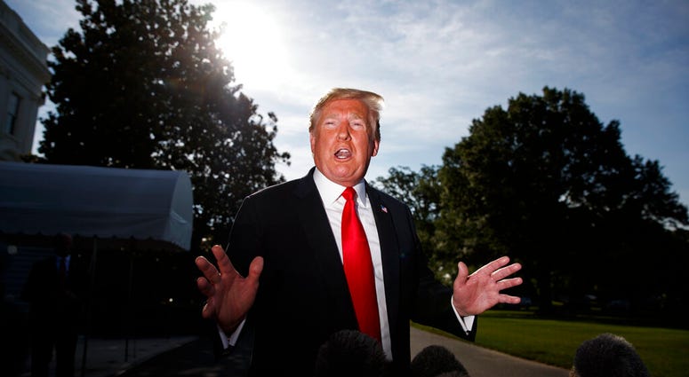 President Donald Trump talks with reporters before departing on Marine One for the Air Force Academy graduation ceremony, Thursday, May 30, 2019, in Washington. AP DO NOT USE