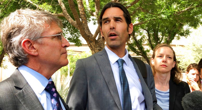 Scott Warren, center, speaks outside federal court, Tuesday, June 11, 2019. in Tucson, Ariz., after a mistrial was declared in the federal case against him. AP DO NOT USE
