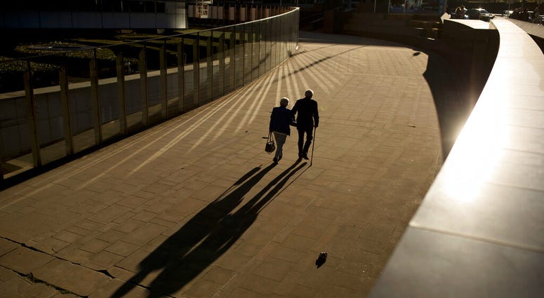 an elderly couple walking an elderly couple walking
