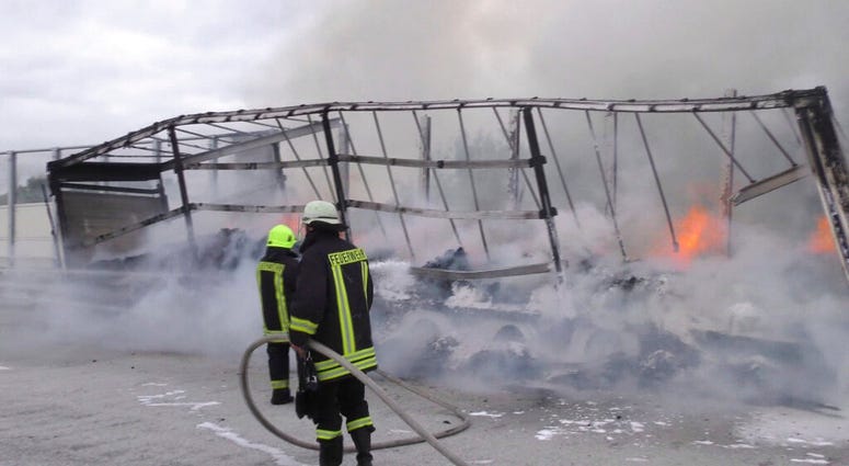 Firefighters attend the scene after a cocoa-laden truck trailer set on fire on the A14 autobahn near Grabow, Germany AP DO NOT USE