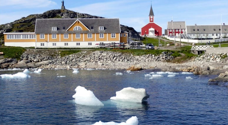 small pieces of ice float in the water off the shore in Nuuk, Greenland AP DO NOT USE