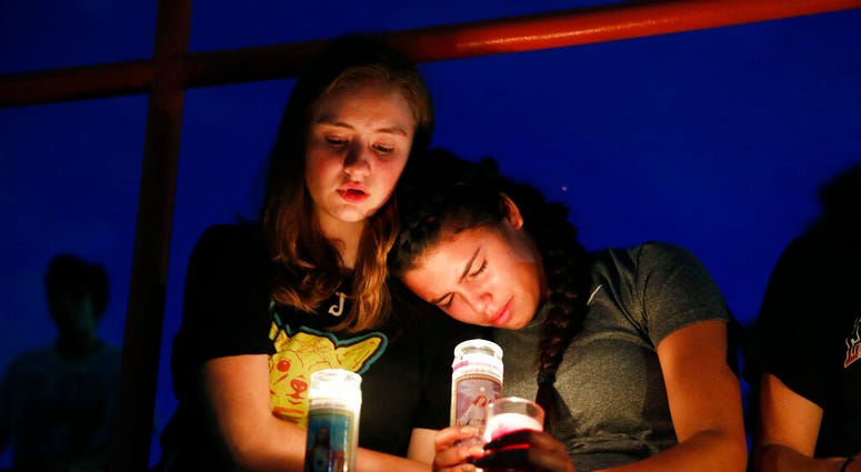 Melody Stout and Hannah Payan comfort each other during a vigil for victims of the shooting that occurred earlier in the day at a shopping center, Saturday, Aug. 3, 2019, in El Paso, Texas. DO NOT USE