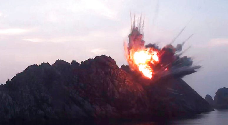 This Tuesday, Aug. 6, 2019, photo provided by the North Korean government shows what it says a new-type tactical guided missile launched from an airfield in the western area of North Korea landing in an islet in waters off the country's eastern coast. AP DO NOT USE