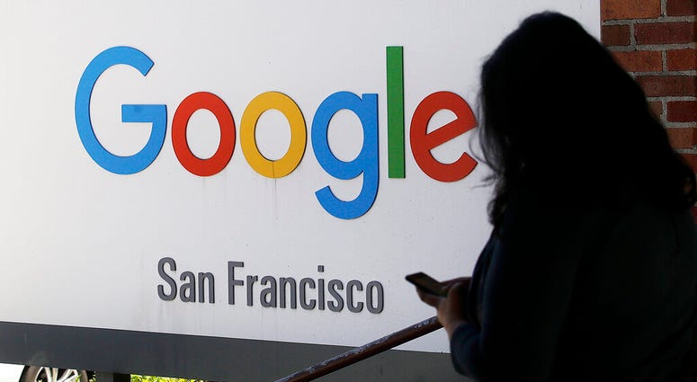In this May 1, 2019, file photo, a person walks past a Google sign in San Francisco. AP DO NO TUSE