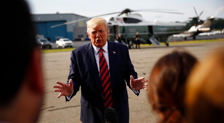 President Donald Trump speaks with reporters before boarding Air Force One at Morristown Municipal Airport in Morristown, N.J., Sunday, Aug. 18, 2019. DO NOT USE