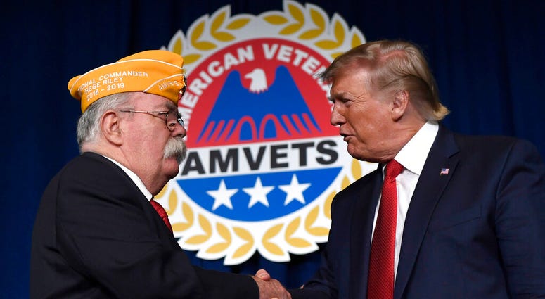 President Donald Trump greets AMVETS national commander Rege Riley at the American Veterans (AMVETS) 75th National Convention in Louisville, Ky., Wednesday, Aug. 21, 2019.