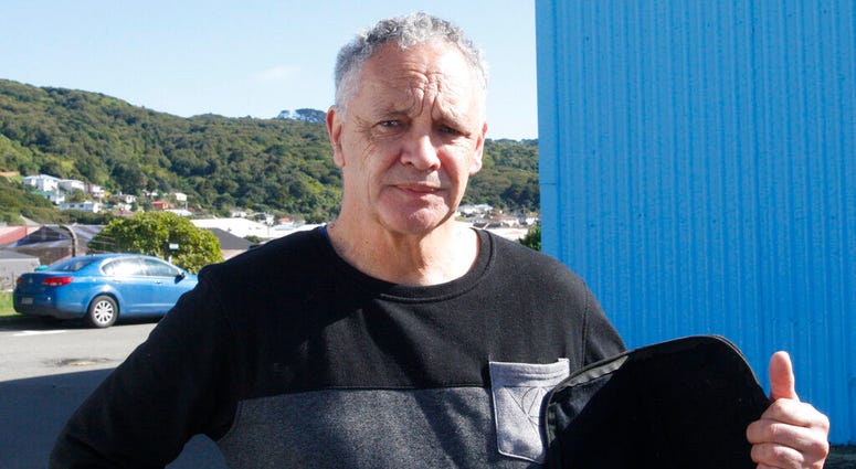 In this Aug. 31, 2019, photo, gun owner Phillip Fee poses holds his gun bag outside a temporary gun collection venue in Porirua, near Wellington, New Zealand. AP DO NOT USE