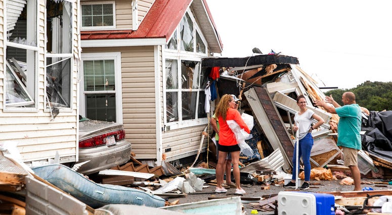 Residents of the Boardwalk RV Park discuss the path of a possible waterspout or tornado, generated by Hurricane Dorian, struck the area, Thursday, Sept. 5, 2019, in Emerald Isle, N.C. Residents of the Boardwalk RV Park discuss the path of a possible waterspout or tornado, generated by Hurricane Dorian, struck the area, Thursday, Sept. 5, 2019, in Emerald Isle, N.C.