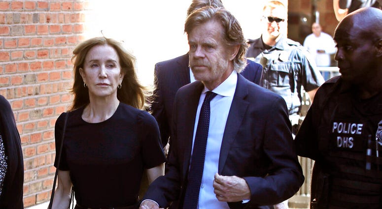 Felicity Huffman arrives at federal court with her husband William H. Macy for sentencing in a nationwide college admissions bribery scandal, Friday, Sept. 13, 2019, in Boston.
