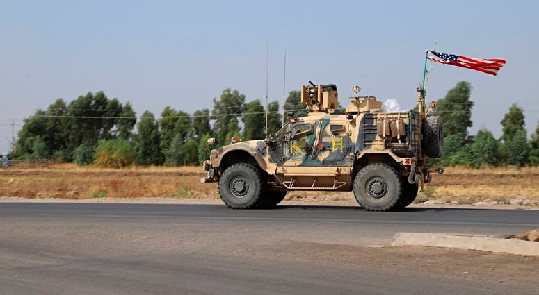 A U.S. military vehicle, part of a convoy, arrives near Dahuk, Iraqi, Monday, Oct. 21, 2019. AP DO NOT USE