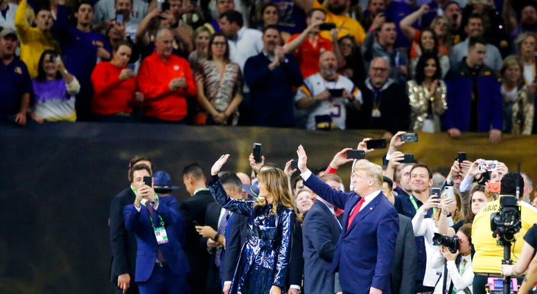 President Donald Trump and first lady Melania Trump arrive for the College Football Playoff National Championship game between LSU and Clemson, Monday, Jan. 13, 2020, in New Orleans.