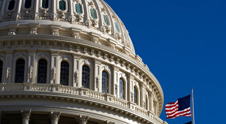 The U.S. flag flies over the U.S. Capitol in Washington, Sunday, Jan. 19, 2020.