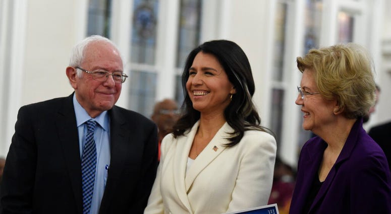 US. Sen. Bernie Sanders, left, I-Vt., U.S. Rep. Tulsi Gabbard, center, D-Hawaii, and Sen. Elizabeth Warren, right, D--Mass., speak at a Martin Luther King Jr. Day services at Zion Baptist Church, Monday, Jan. 20, 2020, in Columbia, S.C.