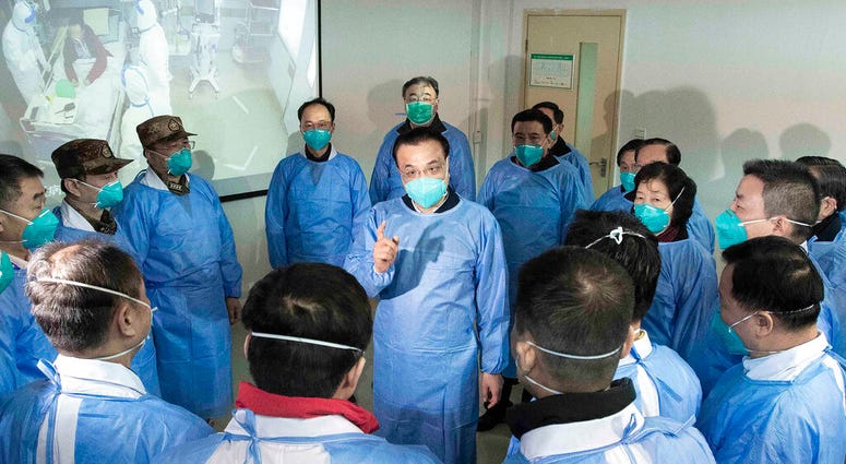 China's Xinhua News Agency, Chinese Premier Li Keqiang, center, speaks with medical workers at Wuhan Jinyintan Hospital in Wuhan in central China's Hubei province, Monday, Jan. 27, 2020.