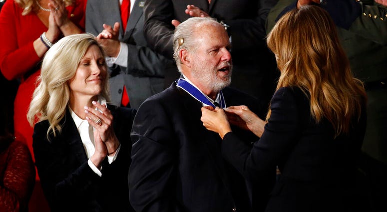 First Lady Melania Trump presents the Presidential Medal of Freedom to Rush Limbaugh as his wife Kathryn watches during the State of the Union address to a joint session of Congress on Capitol Hill in Washington, Tuesday, Feb. 4, 2020.
